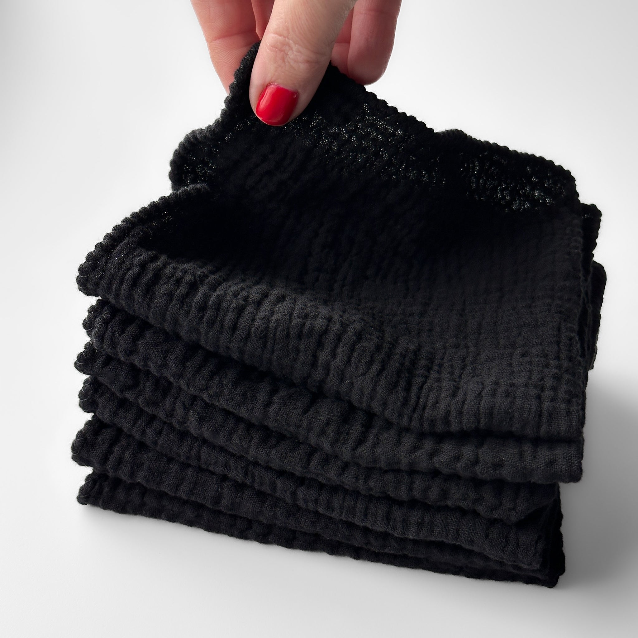 Stack of 7 black makeup remover cloths